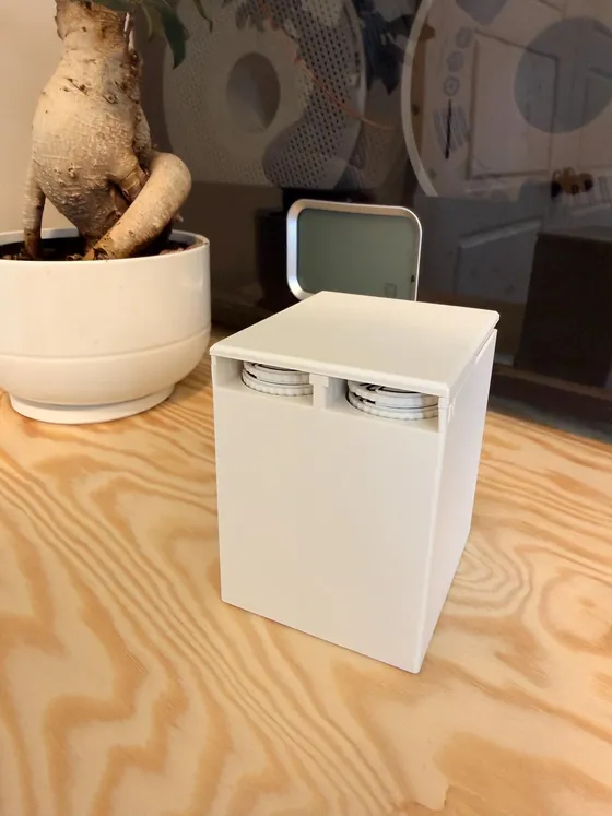 The Commander Cube dispensing a +1/+1 dial